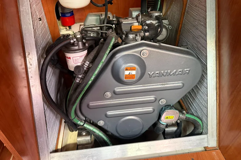 Slide: The Image of Yanmar engine in a 2009 Hunter 38 sailboat, showcasing detailed mechanical components. - 35