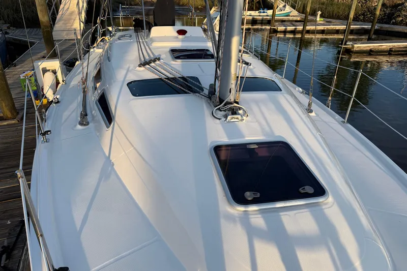Slide: The Image of 2009 Hunter 38 sailboat deck with hatches, docked at marina. - 4