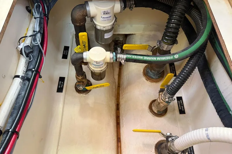 Slide: The Image of Engine compartment of 2009 Hunter 38 sailboat with plumbing and wiring components. - 8