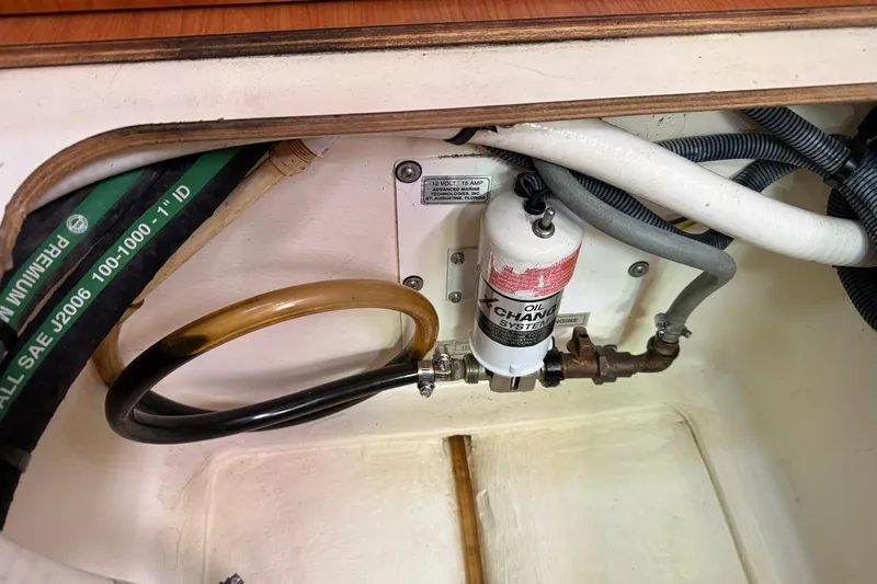 Slide: The Image of Engine compartment of 2009 Hunter 38 sailboat with oil change system and hoses. - 9