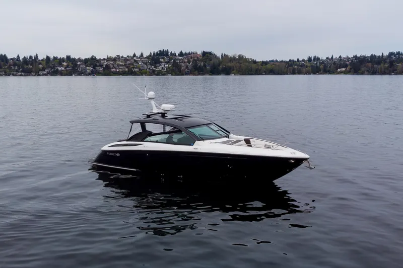 The Image of 2019 Cobalt A36 boat on calm lake with scenic shoreline background. - 0