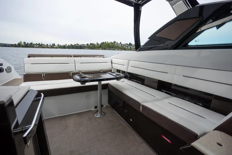 Slide: The Image of Luxurious interior of 2019 Cobalt A36 boat with spacious seating and scenic lake view. - 13