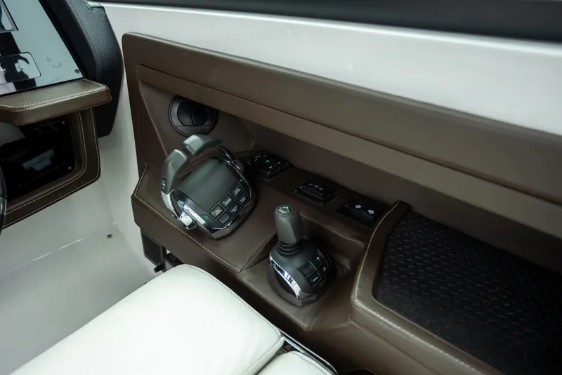 Slide: The Image of 2019 Cobalt A36 boat interior controls with brown leather accents. - 22
