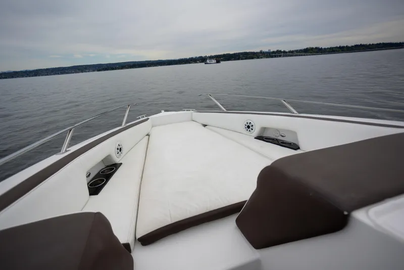 Slide: The Image of 2019 Cobalt A36 boat interior with cushioned seating on calm water. - 24