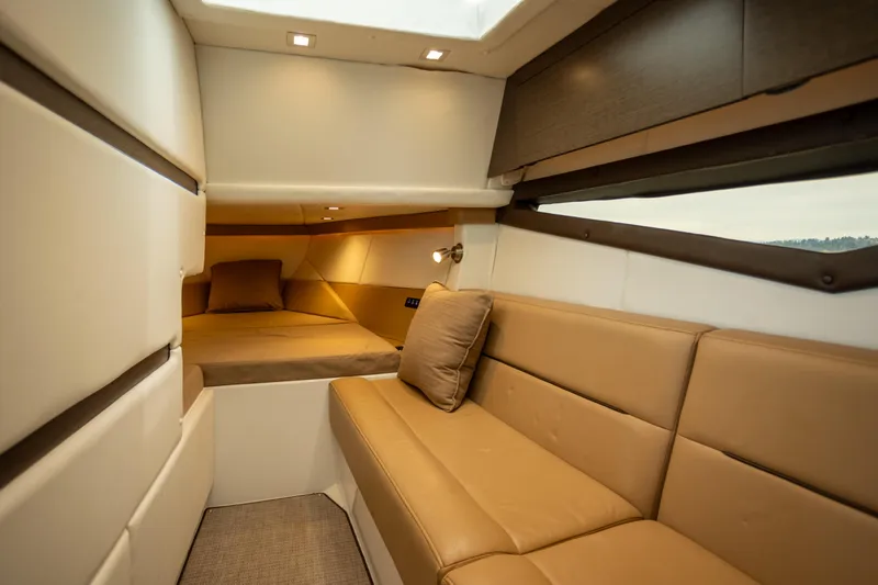 Slide: The Image of Luxurious interior of a 2019 Cobalt A36 yacht with beige seating and cozy sleeping area. - 27