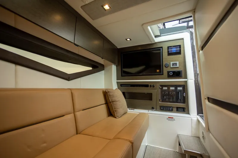 Slide: The Image of Luxurious interior of 2019 Cobalt A36 boat with beige seating and entertainment system. - 28