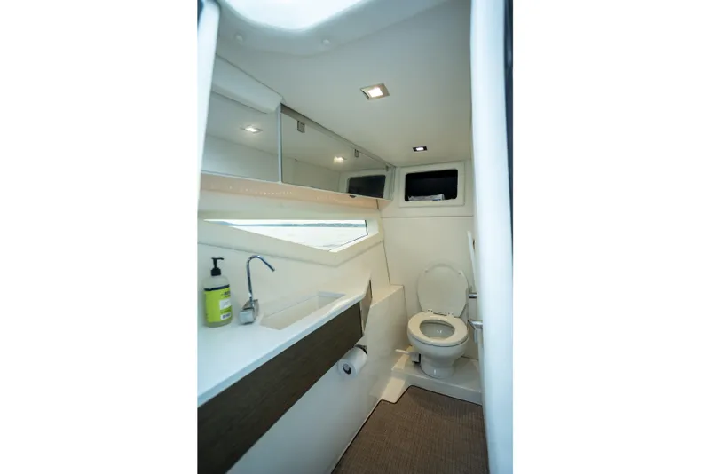 Slide: The Image of 2019 Cobalt A36 boat bathroom interior with modern fixtures and natural lighting. - 29