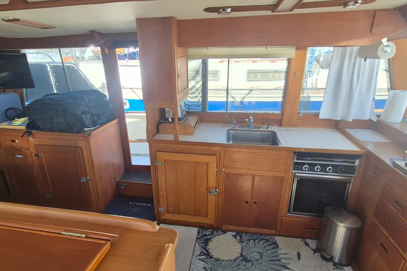 Slide: The Image of Interior of 1983 Grand Banks 42 Motoryacht with wooden cabinetry and kitchen amenities. - 11