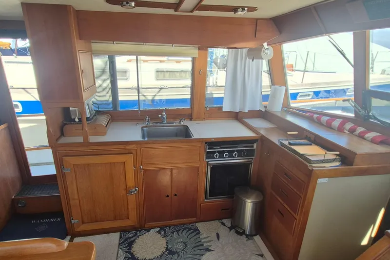 Slide: The Image of Interior of 1983 Grand Banks 42 Motoryacht kitchen with wooden cabinetry and appliances. - 12