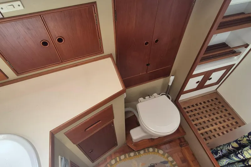 Slide: The Image of Interior of 1983 Grand Banks 42 Motoryacht with wood paneling and patterned bedding. - 17