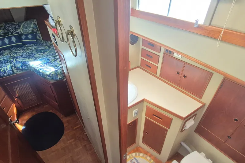 Slide: The Image of Cozy cabin interior of 1983 Grand Banks 42 Motoryacht with patterned bedding and wooden furnishings. - 20