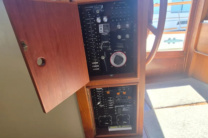 Slide: The Image of Electrical panel of a 1983 Grand Banks 42 Motoryacht with Cummins Onan generator controls. - 25