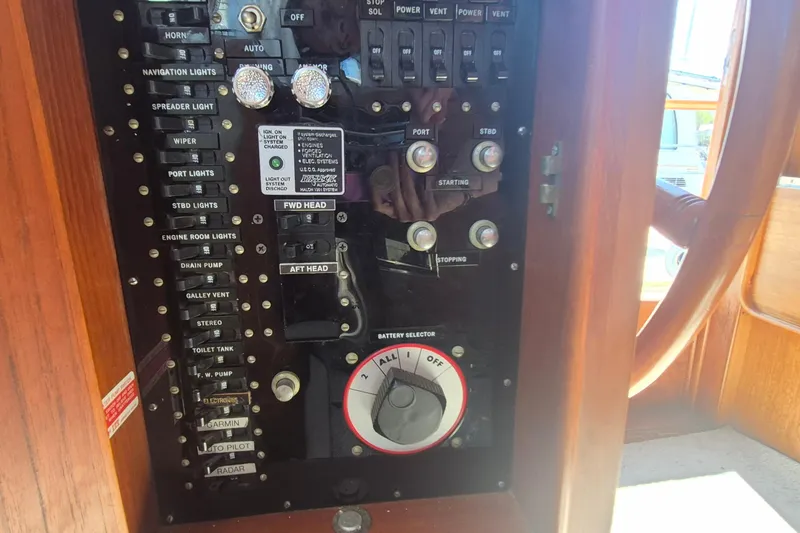Slide: The Image of Electrical panel inside 1983 Grand Banks 42 Motoryacht, showcasing controls and switches. - 26