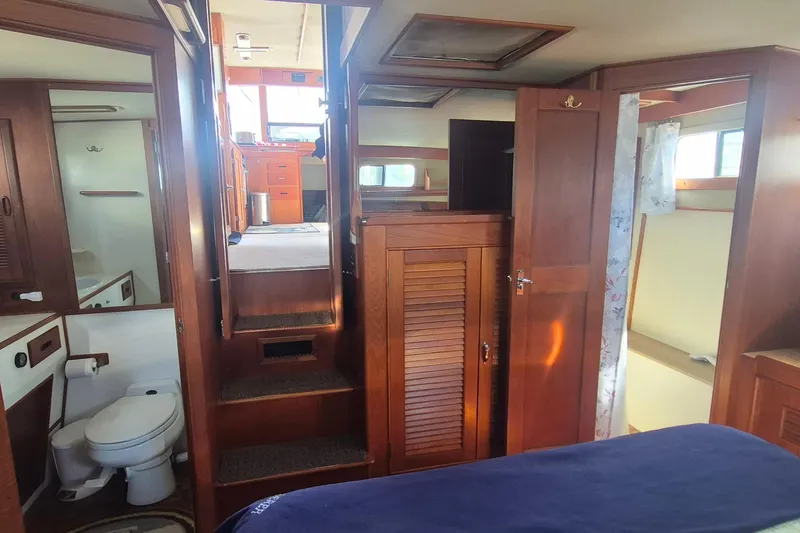 Slide: The Image of Interior of 1983 Grand Banks 42 Motoryacht with wooden cabinetry and cozy living space. - 3
