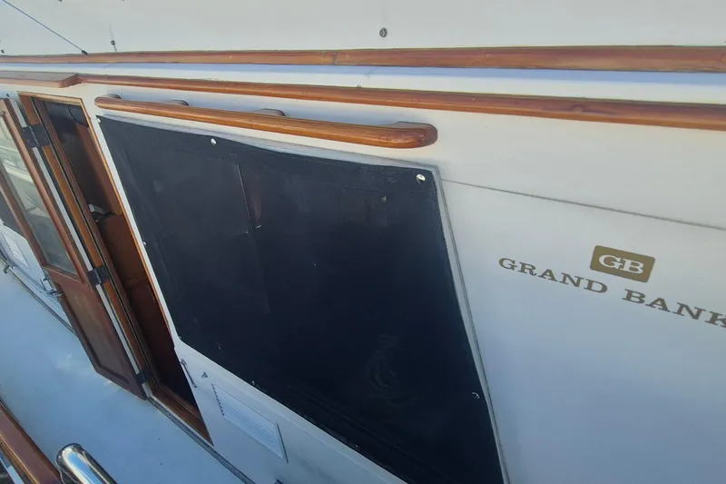 Slide: The Image of 1983 Grand Banks 42 Motoryacht deck with storage boxes and coiled ropes. - 40