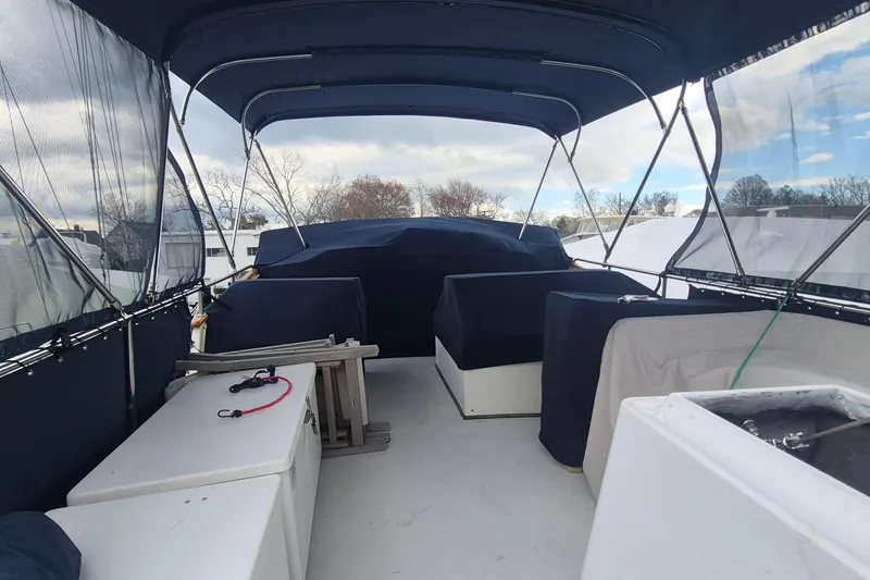 Slide: The Image of 1983 Grand Banks 42 Motoryacht with blue canopy under cloudy sky. - 45