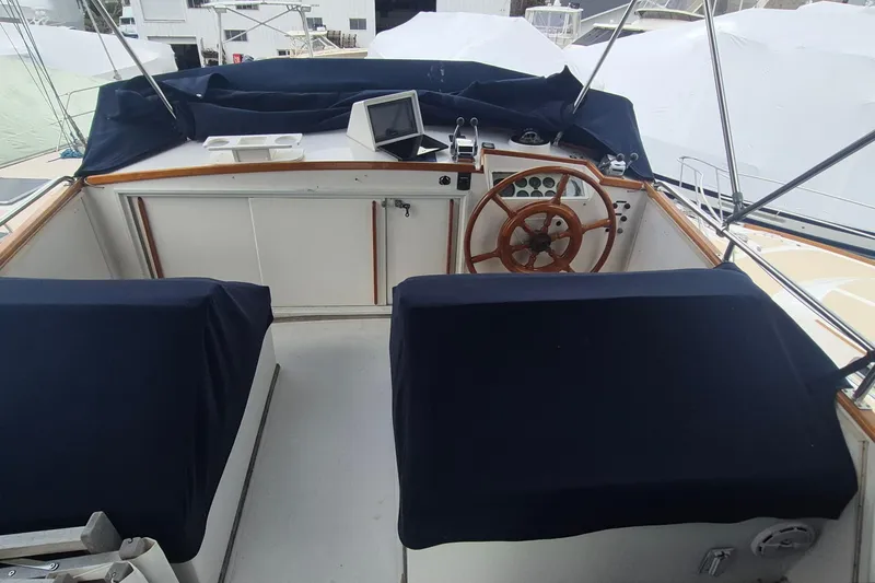 Slide: The Image of 1983 Grand Banks 42 Motoryacht flybridge with covered seating and clear canopy. - 46