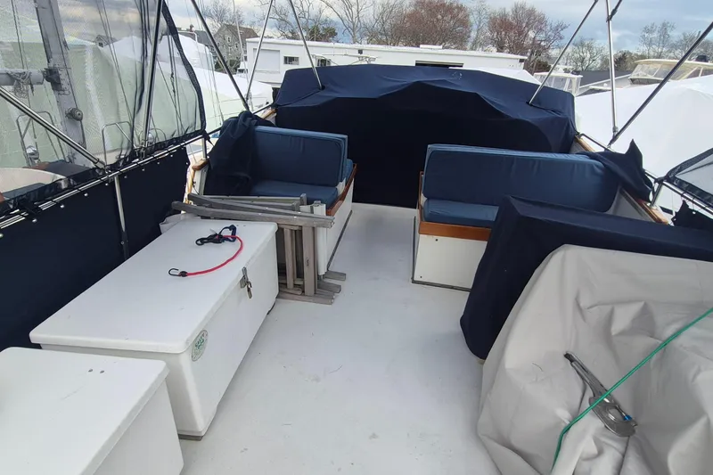 Slide: The Image of 1983 Grand Banks 42 Motoryacht deck with covered seating and canopy. - 52