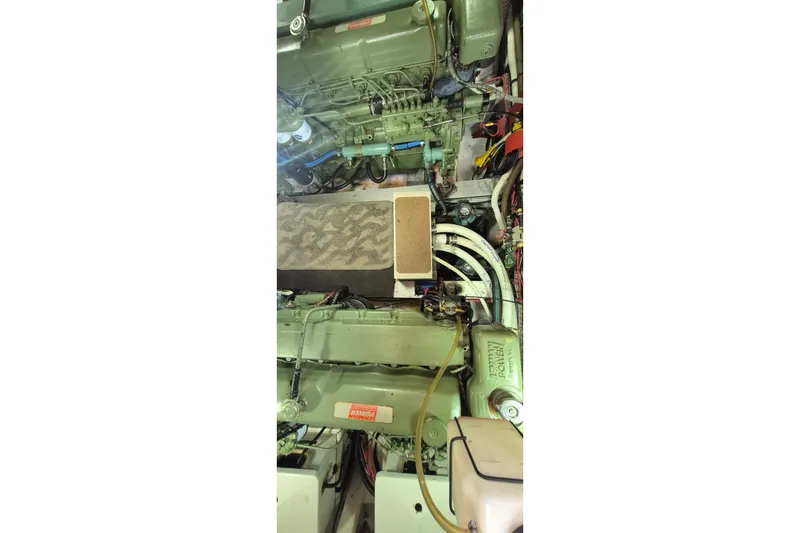 Slide: The Image of 1983 Grand Banks 42 Motoryacht deck with seating and storage, covered in navy canvas. - 53