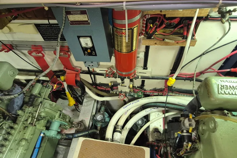 Slide: The Image of Engine room of 1983 Grand Banks 42 Motoryacht, showcasing mechanical components and wiring. - 54
