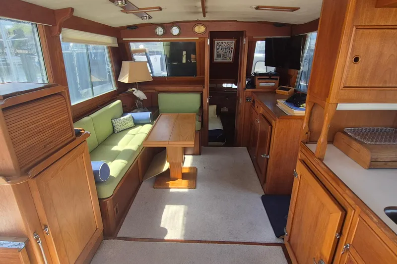 Slide: The Image of Interior of 1983 Grand Banks 42 Motoryacht with wooden furnishings and green seating. - 6