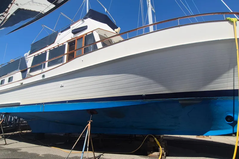 Slide: The Image of 1983 Grand Banks 42 Motoryacht on dry dock, showcasing its classic design and blue hull. - 66