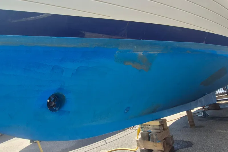 Slide: The Image of 1983 Grand Banks 42 Motoryacht with blue hull, docked under clear sky. - 68