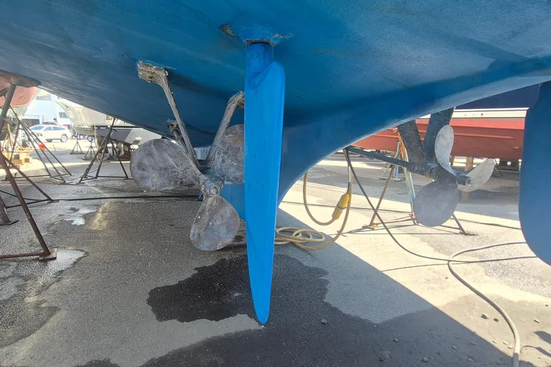 Slide: The Image of Wooden steering wheel from a 1983 Grand Banks 42 Motoryacht in a workshop setting. - 70