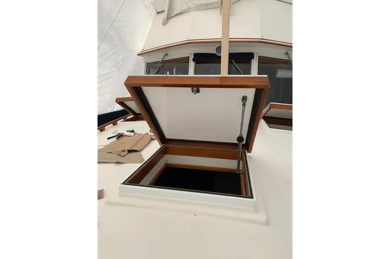 Slide: The Image of Open hatch on 1983 Grand Banks 42 Motoryacht deck, showcasing wooden trim and interior access. - 72