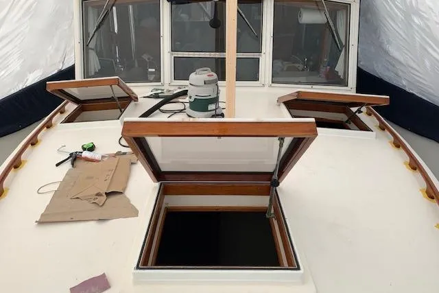 Slide: The Image of 1983 Grand Banks 42 Motoryacht deck with open hatches and maintenance tools. - 73