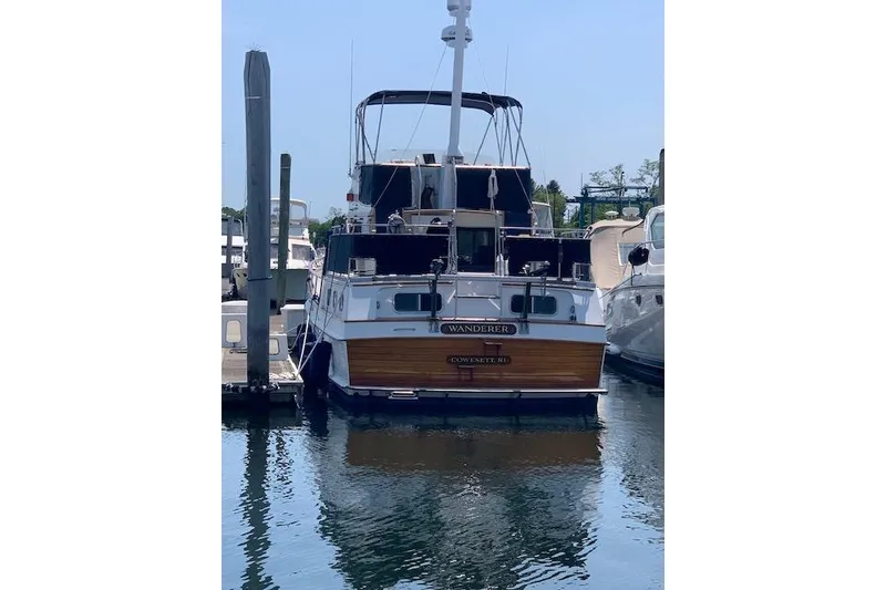 Slide: The Image of 1983 Grand Banks 42 Motoryacht docked at marina, rear view with clear blue sky. - 74