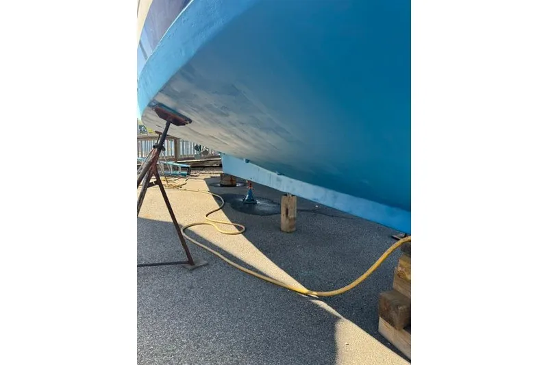 Slide: The Image of 1983 Grand Banks 42 Motoryacht hull on dry dock, supported by stands and blocks. - 79