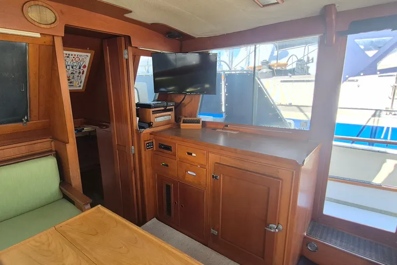 Slide: The Image of Interior of 1983 Grand Banks 42 Motoryacht with wood cabinetry and mounted TV. - 9