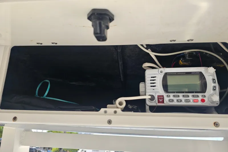 Slide: The Image of Control panel of 2022 NauticStar 28 XS boat with various switches and buttons. - 10