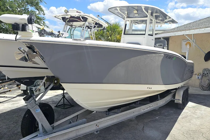 Slide: The Image of Anchor compartment of 2022 NauticStar 28 XS boat with chain and controls. - 16