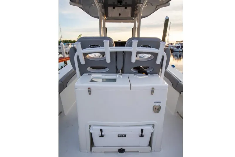 Slide: The Image of 2022 NauticStar 28 XS boat on trailer, parked outdoors under a sunny sky. - 18