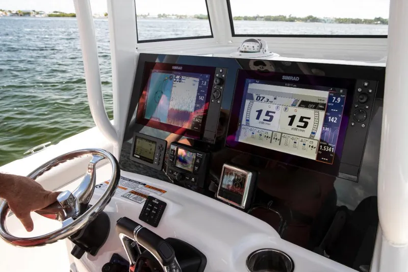 Slide: The Image of 2022 NauticStar 28 XS boat on trailer, parked outdoors under a clear blue sky. - 21