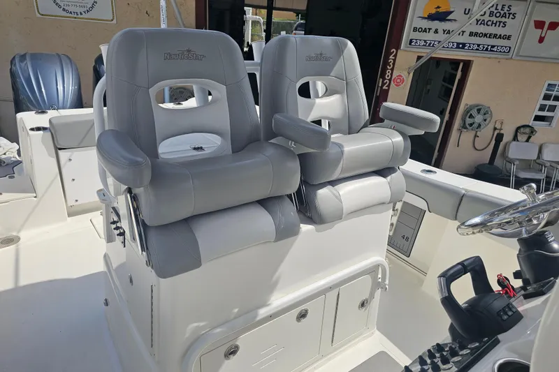 Slide: The Image of Interior seating of 2022 NauticStar 28 XS boat, featuring gray cushioned seats. - 25