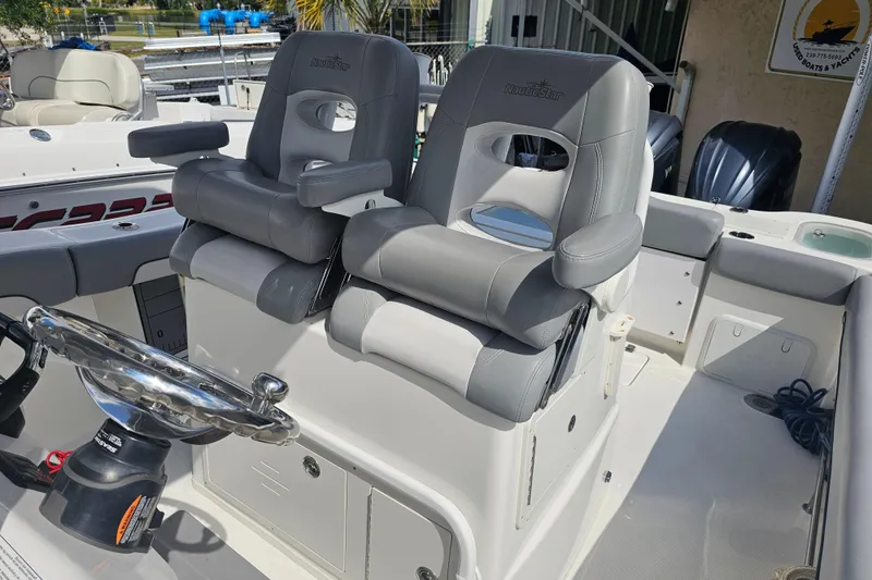 Slide: The Image of 2022 NauticStar 28 XS boat interior with seating and storage compartments. - 26