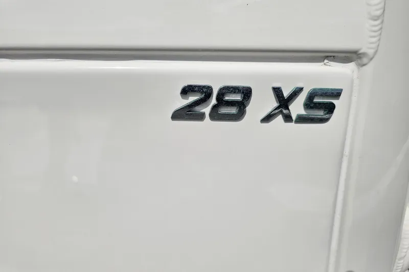 Slide: The Image of 2022 NauticStar 28 XS boat with dual cushioned captain's chairs and control panel. - 27