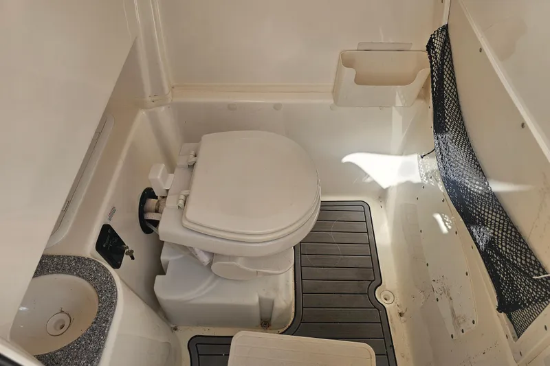 Slide: The Image of 2022 NauticStar 28 XS boat interior with dual gray captain seats. - 28