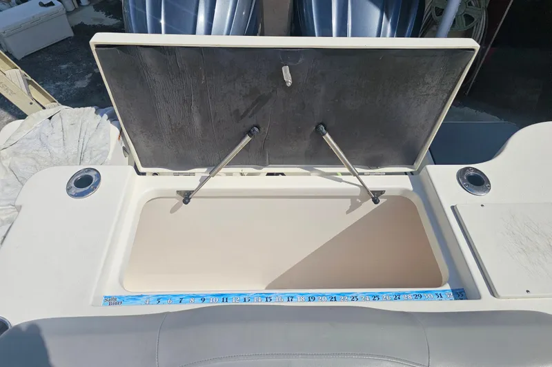 Slide: The Image of 2022 NauticStar 28 XS boat interior with seating and cup holder. - 32