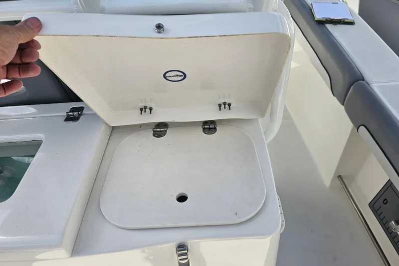 Slide: The Image of Open livewell on 2022 NauticStar 28 XS boat, showcasing interior design and functionality. - 35