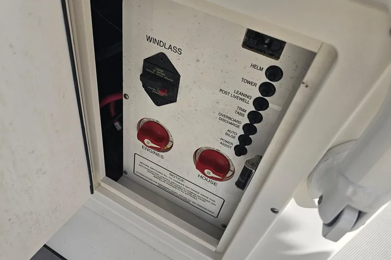 Slide: The Image of Battery compartment of 2022 NauticStar 28 XS boat with multiple batteries and wiring. - 40