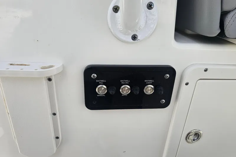 Slide: The Image of 2022 NauticStar 28 XS boat seats, gray upholstery, armrests, and deck view. - 43