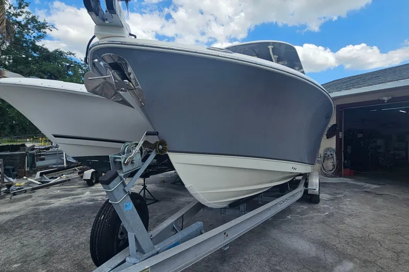 Slide: The Image of 2022 NauticStar 28 XS boat on trailer, parked outdoors under blue sky. - 5