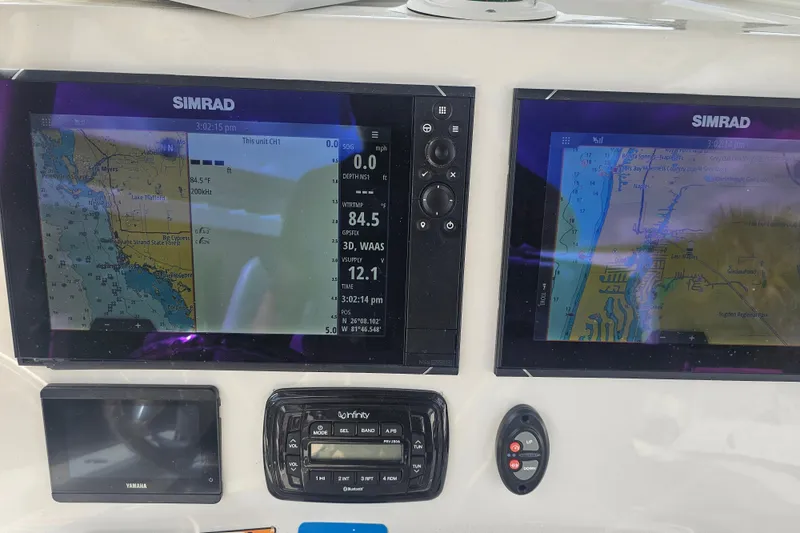 Slide: The Image of 2022 NauticStar 28 XS boat on trailer, parked outdoors under blue sky. - 7