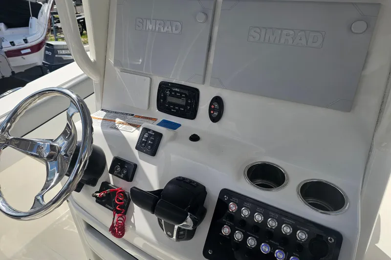 Slide: The Image of Simrad navigation screens on a 2022 NauticStar 28 XS boat dashboard. - 9