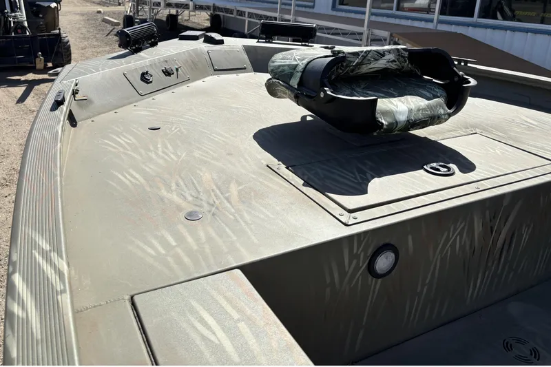 Slide: The Image of 2024 Tracker Grizzly 1654 T Sportsman boat deck with camouflage seat and rugged design. - 3