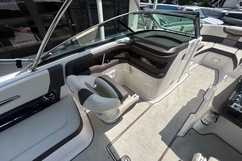 Slide: The Image of 2018 Chaparral 267 SSX boat interior with sleek seating and modern dashboard design. - 14